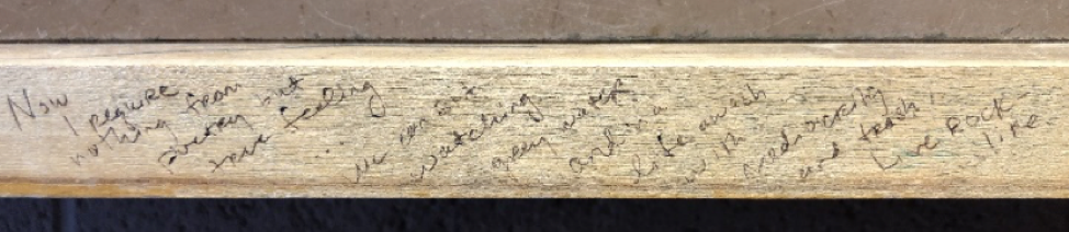 A rim of soft wood with faint writing