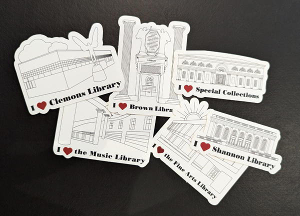 The image shows a collection of six stickers, each featuring a line drawing of a different library or library section with the text "I ♥" followed by the library's name. The libraries are: Clemons Library Brown Library Special Collections The Music Library Shannon Library The Fine Arts Library Each sticker includes a simple architectural illustration of the corresponding library, along with the phrase "I ♥" and the name of the library below the drawing. The stickers are arranged in a scattered layout on a dark background.
